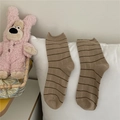 Light brown striped Morandi style mid-calf socks displayed on a soft white pillow - One Size / Rice Camel