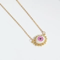 Close-up of golden Devil's Eye necklace with pink zircon accents on white background - Pink