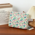 Floral quilted toiletry bag with zipper closure on a cozy wooden background - Medium Makeup Bag