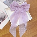 Detail van een lila chiffon haarstrik met witte stippen en lange kwastjes op de clip - Lange lint veerclip / Paarse Stippen