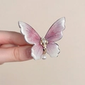 Detailed close-up of butterfly hair clip with pink gradient resin and pearl pendant - Hair Bow / Pink