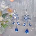 Detail of blue crystal fringe earrings with floral studs and teardrop pendants - Ear Hook Style / Blue
