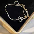 Elegant gold double heart bracelet with white zircon pave on a black velvet display - Gold Hollow Heart