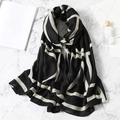 Fashionable black and white cotton linen scarf with geometric stripes in a flat lay - Black White Geometric