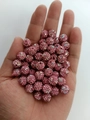Macro view of a 10mm pink disco ball bead with rhinestones held in palm for scale - 10mm / Light Pink AB
