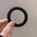 Glossy black spiral hair tie made of high-quality resin with a seamless elastic design - Single Piece / Jelly Black