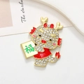 Macro shot of cartoon dragon alloy badge with white rhinestones and golden Fu character - Dragon Fortune - Matte Gold