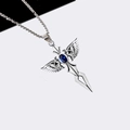 Macro shot of silver cross pendant with blue gemstone and wings on a box chain - Blue Angel Wing Sword