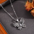 Detail view of a silver butterfly pendant necklace with sparkling zircon pavé setting - Silver Black Pattern Bowknot Necklace