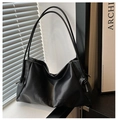 Detail of black matte PU tote bag featuring side drawstrings and brand letter embossing - Black