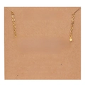 Macro view of gold Sagittarius necklace on vintage kraft paper card with character description - Gold-Sagittarius