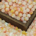 Close-up of 8mm gradient pink and orange translucent glass beads in a dark wooden box - 10mm / N15# Yellow Nutmeg (10MM)