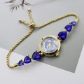 Detail of gold heart charm watch featuring blue marble dial and sparkling gemstones - Gold Blue