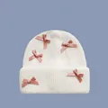 White knitted beanie with pink satin bows featuring coquette aesthetic style for winter - One Size / White/Pink Bow