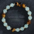 8mm Green Aventurine and Tiger Eye beaded health bracelet on black textured background - Green Aventurine Tiger Eye With Gold Spacer (Health-2)