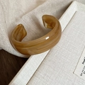 Close-up of a wide wavy resin bangle with dark amber marble texture on linen fabric - 49# Bracelet-Dark Coffee Open Amber