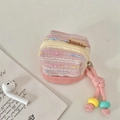 Detail of tweed weave texture and colorful bead zipper charm on a pink earphone pouch - Pink