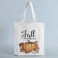 Detail of canvas tote bag featuring autumn pumpkin illustrations and Fall theme text - Favorite Color Illustration