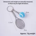 Mini silver tennis racket keychain with a vibrant blue felt ball and metal keyring - 2cm Small Blue Tennis Ball + Silver Racket