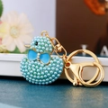 Close-up of light blue pearl duck keychain with golden metal ring and lobster clasp detail - Sky Blue Pearl Duck