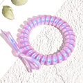 Detailed close-up of a purple iridescent spiral hair tie with a decorative bow - Purple