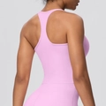 Close-up of pink racerback sports bra showing elastic fit and seamless back design - Sakura Pink