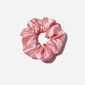Close-up of pink satin scrunchie showing smooth silk texture and pleated design - Pink
