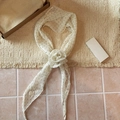 Detail of white polka dot silk scarf necklace with a central rose knot design - White Polka Dot (Necklace Style)