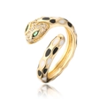 Macro detail of gold-plated snake ring with enamel spots and green crystal eyes - Black / White (12112)
