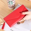 Red long envelope-style wallet for women with heart pendant and tassel in litchi grain - Red