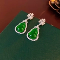 Macro shot of green gourd-shaped stud earrings with sparkling zircon on dark green box - Silver Earring Post Gourd Zirconia Stud Earrings