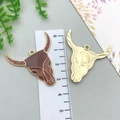 Golden bull head pendant with brown enamel detail, shown with ruler for size scale - 1Pc Bull Head (Brown)