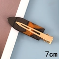 Detail shot of a 7cm amber acetate hair clip with a golden metal duckbill grip - 7# Acetate 7cm Seamless Clip