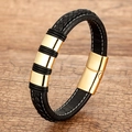 Geflochtenes schwarzes Lederarmband mit Goldringen und Magnetverschluss auf Holz - Goldener Ring Schwarzes Leder-Stil 2