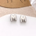 Polished silver letter M stud earring with 3D minimalist design on a white pedestal - Silver Letter M