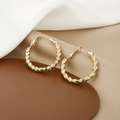 Elegant gold hoop earrings with twisted metal texture on a minimalist fabric background - Gold Twisted Texture Hoop Earrings (E1341-2)