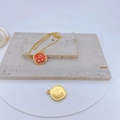 Macro detail of gold-plated necklace with red enamel square pendant on stone - Red Number 8 Square