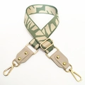 Detailed view of green and beige woven adjustable wide canvas bag strap with gold metal hooks - No.6 Beige Leaf Jacquard + Beige Grey Leather