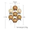 Bohemian handwoven white cotton hat organizer rack for wall display holding seven straw hats - Assorted Elements