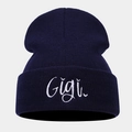 Detailed view of white Gigi embroidery on navy blue knit beanie with ribbed texture - One Size / Navy Blue