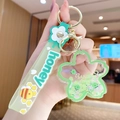Green sakura blossom keychain with floating sequins and honey-themed silicone strap - Sakura - Green