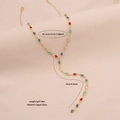 Gold Y-shaped necklace with colorful oval crystals and adjustable size details - Ellipse