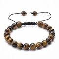 Macro detail of hand-woven tiger eye stone bracelet with adjustable braided black cord - Tiger's Eye