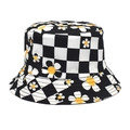 Detailed view of reversible checkerboard bucket hat with sunflower daisy print texture - Black