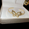 Detailed macro view of a gold-plated leaf-style bracelet with sparkling zircon inlays - Gold