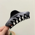 Close-up of a 12cm matte black shark hair claw clip held in hand for size comparison - Matte Black