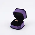 Purple octagonal velvet jewelry box with golden ring and pink gemstone centerpiece - Ring Box / Purple With Black Interior