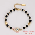 Detail of gold stainless steel bracelet with black faceted beads and evil eye charm - Evil Eye Pendant Style