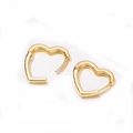 Detailed view of heart-shaped gold huggie earrings with polished mirror finish - Heart / Gold