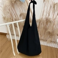 Detail of minimalist black canvas tote bag with adjustable knotted shoulder strap - Black